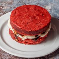 Big Mama · Red velvet cheesecake sandwich finished                    with cream cheese and pecans