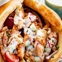 Chicken Gyro · Sliced chicken set on pita bread topped with lettuce, tomatoes, onions and tzatziki sauce se...