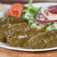 Dolmades · Four tender grape leaves stuffed with ground beef, rice, tomato, and herbs with Greek salad.