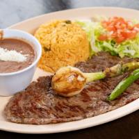 Carne Asada (Grilled Steak) · Marinated grilled steak with grilled scallion on top accompanied with 5 tortillas and 2 opti...