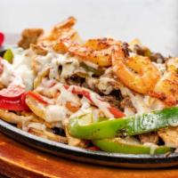 Fajitas Mixta (Steak, Chicken & Shrimp Fajitas) · Marinated grilled strips of beef, chicken, and shrimp seared with cheese, onions, bell peppe...