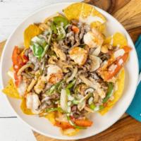 Fajitas Nachos · Chicken, steak and shrimp grilled with onions, bell peppers and tomatoes. Topped with cheese...