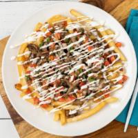 Carne Asada Fries · French fries topped with grilled steak, pico de gallo, sour cream and cheese dip.