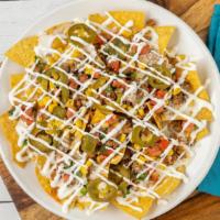 Nachos Supreme · Ground beef, cheese dip, corn, pico de gallo, pickled jalapeños and sour cream. Substitute s...