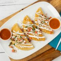 Fried Empanadas (Chicken) · Homemade corn pastries stuffed with cheese, shredded chicken, topped with sour cream, pico d...