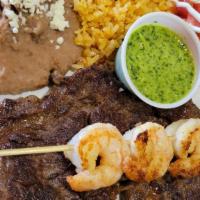 Steak Tampiqueño · Grilled shrimp and steak. Served with Rice, Beans, Side Salad and your choice of Flour Torti...