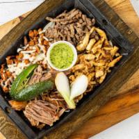 The Stadium (La Parrilla Mix) · Grilled chicken, skirt steak, carnitas, Al pastor and grilled onions. Topped with chiles tor...