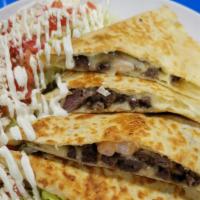 Surf & Turf Quesadilla · A flour tortilla stuffed with cheese, steak and shrimp served with a side sriracha ranch and...