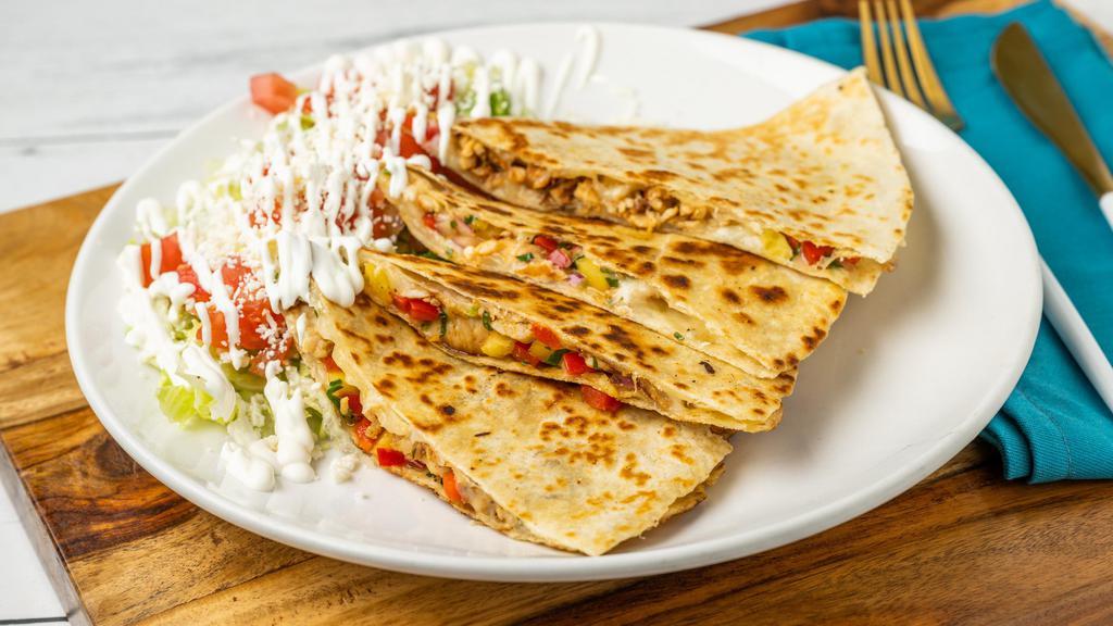 Hawaiian Chicken Quesadilla · A flour tortilla stuffed with cheese, grilled chicken, pineapple salsa and sriracha salsa. Served with lettuce, pico de gallo and sour cream.