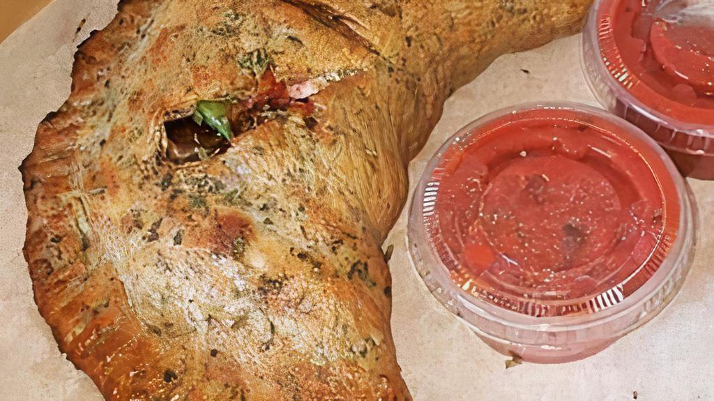 Philly Calzone · (CALZONES DO NOT COME ON GLUTEN-FREE)Roasted Basil Pizza Sauce, Vegan Mozzarella Cheese, Mild Beyond Sausage, Bell Peppers, Red Onions & Portabella Mushrooms.