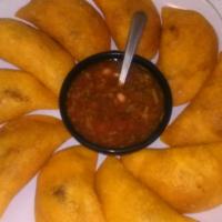 Empanadas Colombianas · Corn flour patty filled with ground beef or chicken and marinated Colombian spices.
