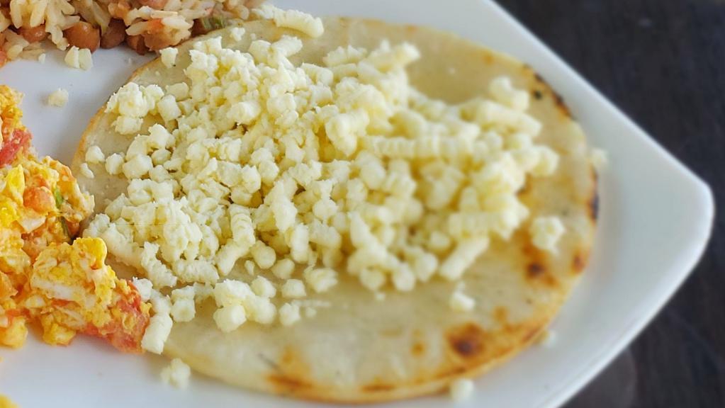 Arepa Con Queso · White corn bread with butter and cheese.