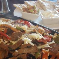 Fajitas Mexicanas · Grilled steak or chicken with tomatoes, onions and bell peppers served with ettuce, guacamol...