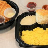 Waffle Breakfast · 2 eggs served with choice of meat, choice of side and a homemade golden waffle and a fluffy ...