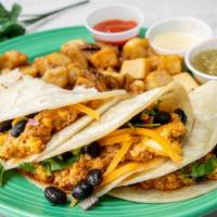 Three Amigos Breakfast Tacos* · Three corn tortillas stuffed with scrambled eggs, yellow cheddar cheese, chicken chorizo, bl...