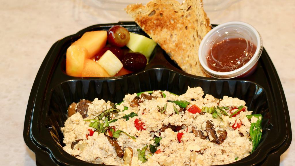 Vegan Tofu Scramble · Tamari-marinated tofu scrambled with red and green peppers, onions, spinach and mushrooms served with fresh fruit, whole wheat toast and cranberry apple butter.