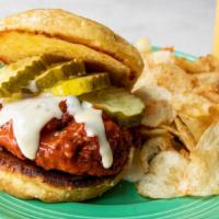 Hot-Lanta Chicken Sandwich · Signature Hot chicken tenders, drizzled with queso, topped with pickles and served on a brio...