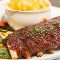 Baby Back Ribs(Half Rack) · Smothered in our BBQ sauce and with a choice of two sides.