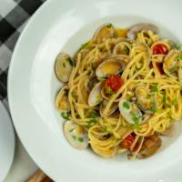 Linguine Alle Vongole · Pasta with baby clams sautéed in white wine and cherry tomatoes.