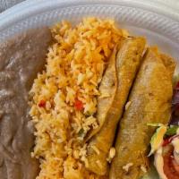 Flautas De Pollo  · Two crispy rolled corn tortillas stuffed with chicken with Rice, Refried Beans and Salad