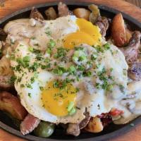 Grilled Steak Skillet · Marinated grilled steak, red potatoes, red and green peppers, onions, over medium egg, toppe...