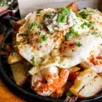 Gulf Shrimp Skillet · Gulf Shrimp sitting on a bed of house made potatoes along with green, red peppers and yellow...