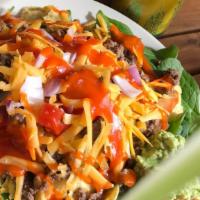 Taco Salad · Fresh spinach greens, corn chips, tomatoes, cabbage, cheese, onion and choose catalina, bals...