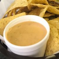 Queso & Chips · Blend of cheddar cheeses, served with organic corn chips.