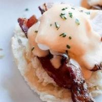 Eggs Blackstone · Applewood-smoked bacon and grilled red tomato over a housemade buttermilk biscuit, topped wi...