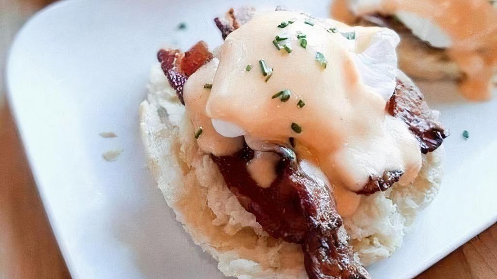 Eggs Blackstone · Applewood-smoked bacon and grilled red tomato over a housemade buttermilk biscuit, topped with two poached eggs and finished with hollandaise