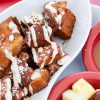 French Toast Bites · Brioche-based French toast bites, fried and tossed in cinnamon sugar, served with cream chee...