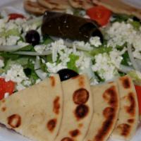 Large Greek Salad · Most popular. Romaine and iceberg lettuce, tomatoes, cucumbers, olives, onions stuffed grape...