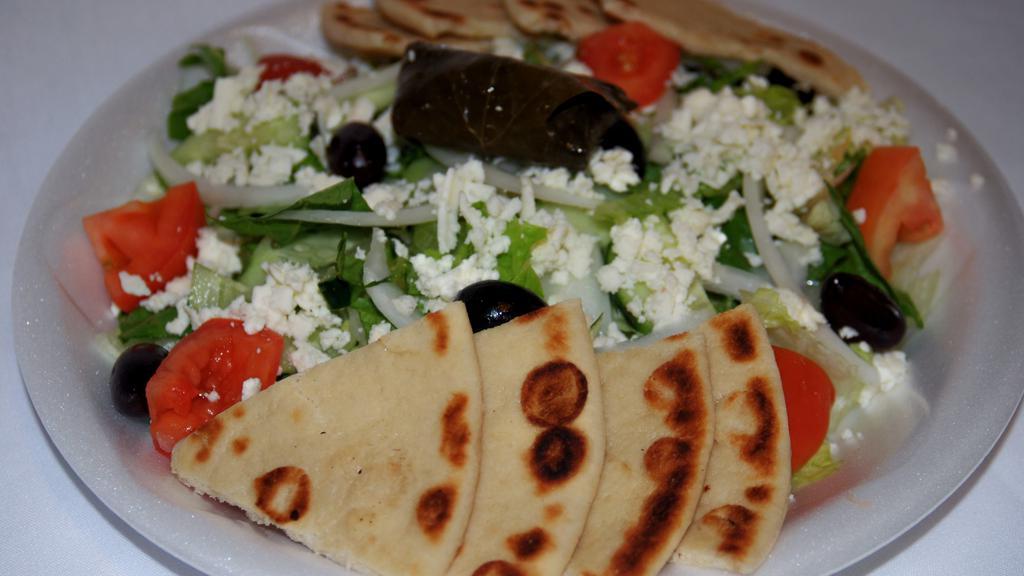 Large Greek Salad · Most popular. Romaine and iceberg lettuce, tomatoes, cucumbers, olives, onions stuffed grape leaf and feta cheese with Greek balsamic dressing.
