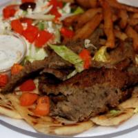 Gyro Plate · Shaved roast lamb and beef served over sliced pita with a side Greek salad, Greek fries, wit...