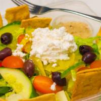 Fattoush Salad · Romaine hearts, tomatoes, cucumbers, olives, feta cheese, pita chips, banana peppers with le...