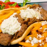 Gyro · Tender lamb meat with lettuce, tzatziki sauce, tomato, onion & a few fries inside a grilled ...