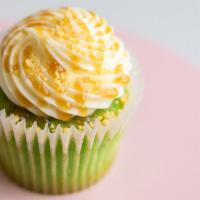 Green Machine Cupcake · Key lime cake topped with cream cheese icing and a lemon crunch drizzled with caramel.