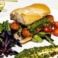 Beyond Chimichurri Sandwich · Beyond sausage, homemade chimichurri sauce,, lettuce and tomato on a ciabatta bread.