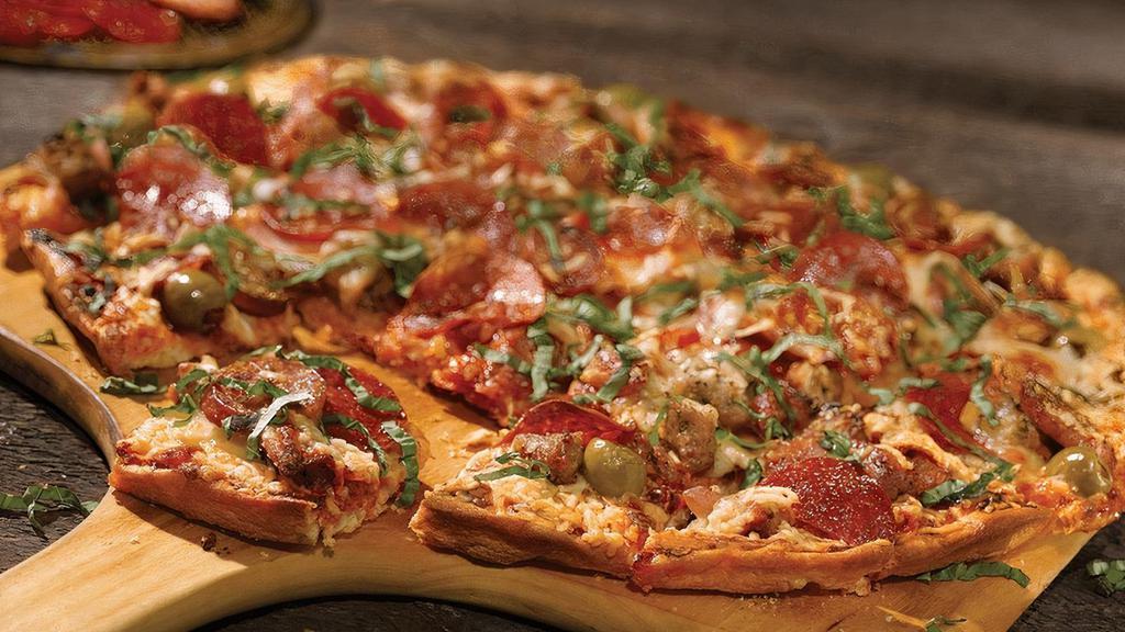 Meat Me™ · Italian sausage, Canadian bacon, Andouille sausage, pepperoni, green olive and fresh basil garnish.
