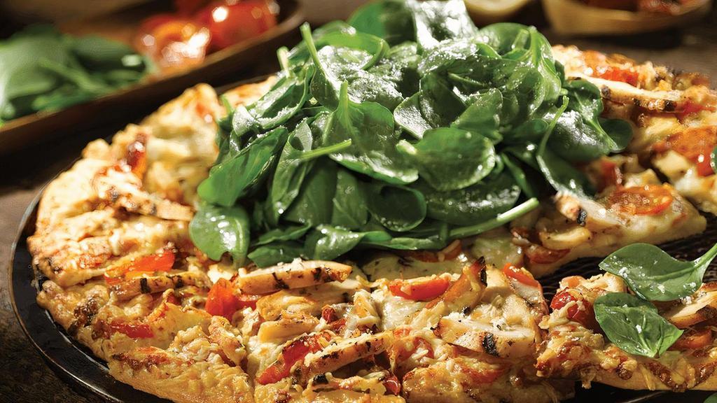 Tuscan Chicken With Spinach  · Lemon garlic sauce, sun-dried tomatoes, applewood-spiced chicken, tomatoes, roasted garlic, fresh spinach tossed in a lemon vinaigrette.