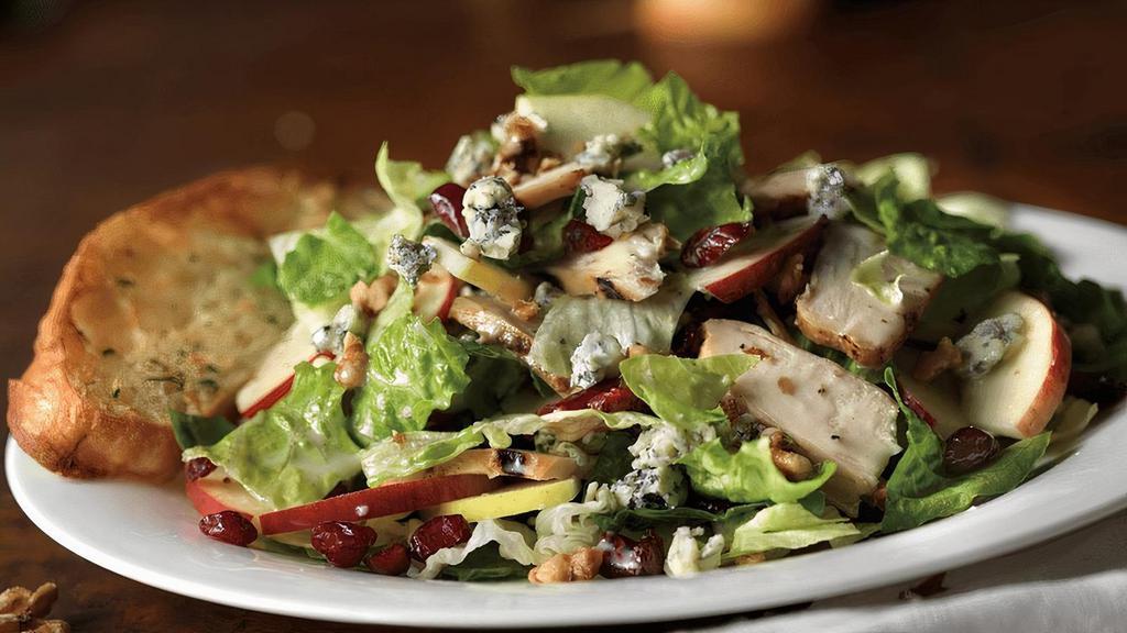Roasted Chicken & Apple Walnut Salad · Fresh greens, bleu cheese crumbles, apple slices, toasted walnuts, sun-dried cranberries and applewood-spiced chicken. Enjoy with creamy herb dressing.