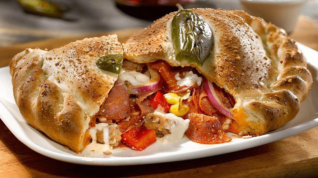Chicago Fire Calzone · Pepperoni, salami, sweet Italian sausage, red peppers, red onions, pepperoncini, mozzarella, ricotta. Topped with a fresh jalapeño baked into the crust. Served with house-made ranch.