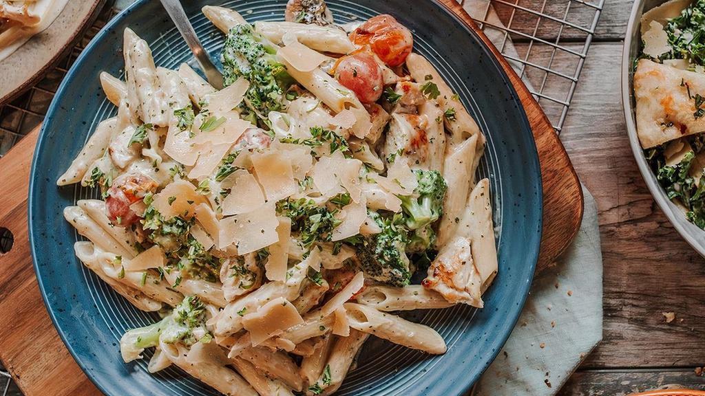 Chicken Pesto Alfredo · Penne Alfredo with applewood chicken, broccoli, roasted mushrooms, blistered tomatoes, pesto and shaved parmesan.