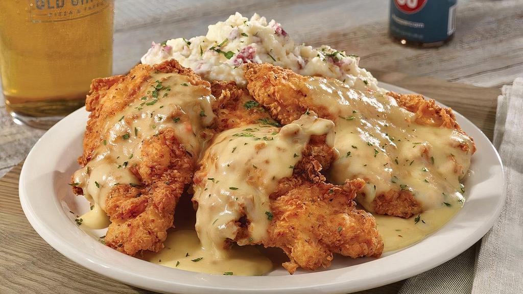 Chicken Fried Chicken · Hand-breaded chicken cutlet dipped in buttermilk and seasoned flour, served crispy over mashed potatoes with our signature chicken gravy.