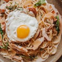 Chicken Carbonara · Spaghetti tossed with garlic parmesan cream sauce,  blistered tomatoes, basil, arugula, blac...