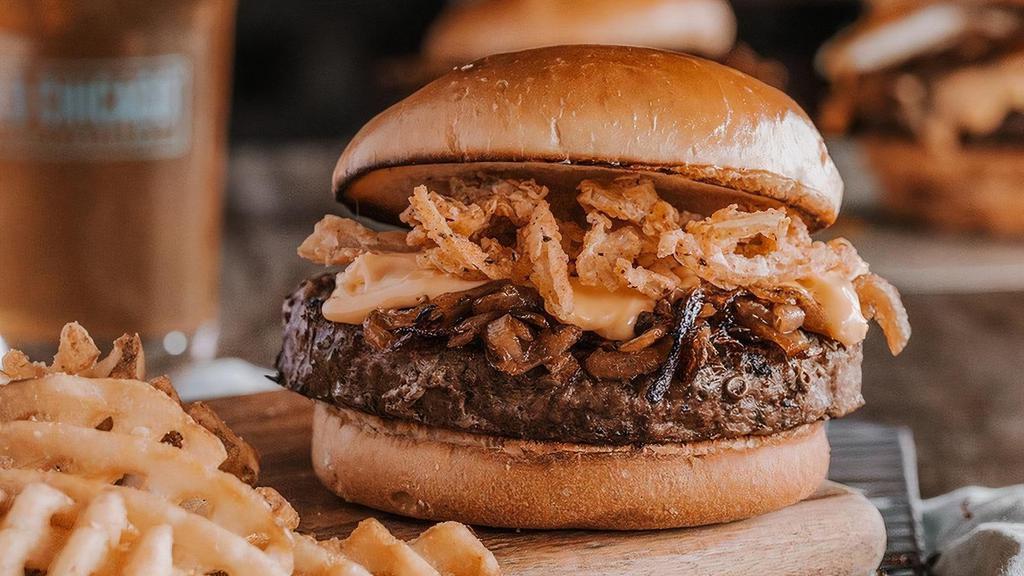 Crafted Beer Burger* · USDA Choice ground chuck burger grilled with a light lager & smothered in caramelized onions & beer cheese sauce made with Guinness, crispy onion strings.