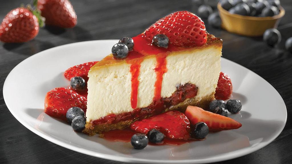 Cheesecake With Fresh Berries · New York-style cheesecake on a graham cracker crust, fresh strawberries & blueberries, drizzled with strawberry sauce.