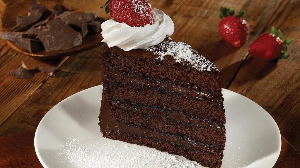 Dark Chocolate Fudge Cake  · Four layers of chocolate cake & rich fudge frosting, whipped cream, powdered sugar & a strawberry.