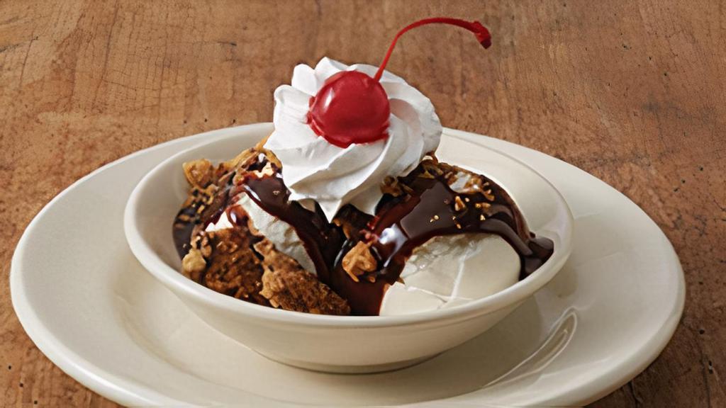 Cookie Sundae · Two scoops of vanilla ice cream with . chocolate syrup, whipped cream, chocolate . chip cookie chunks and a cherry on top!