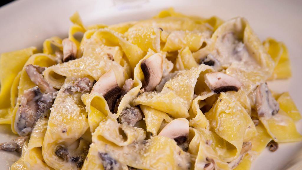 Pappardelle Ai Porcini · Al dente Pappardelle, with Mushrooms sautéed in Olive Oil,
Parmesan Cheese, Bechamel Sauce & Truffle Oil.